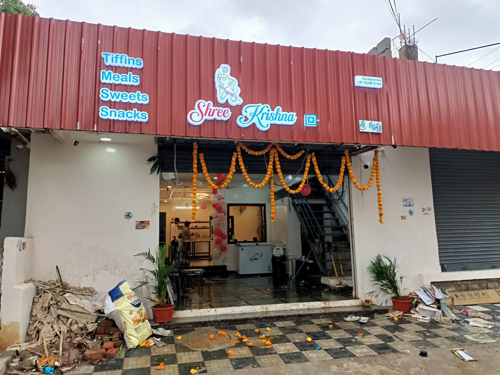 Open kitchen with chef cooking dosas on the tawa